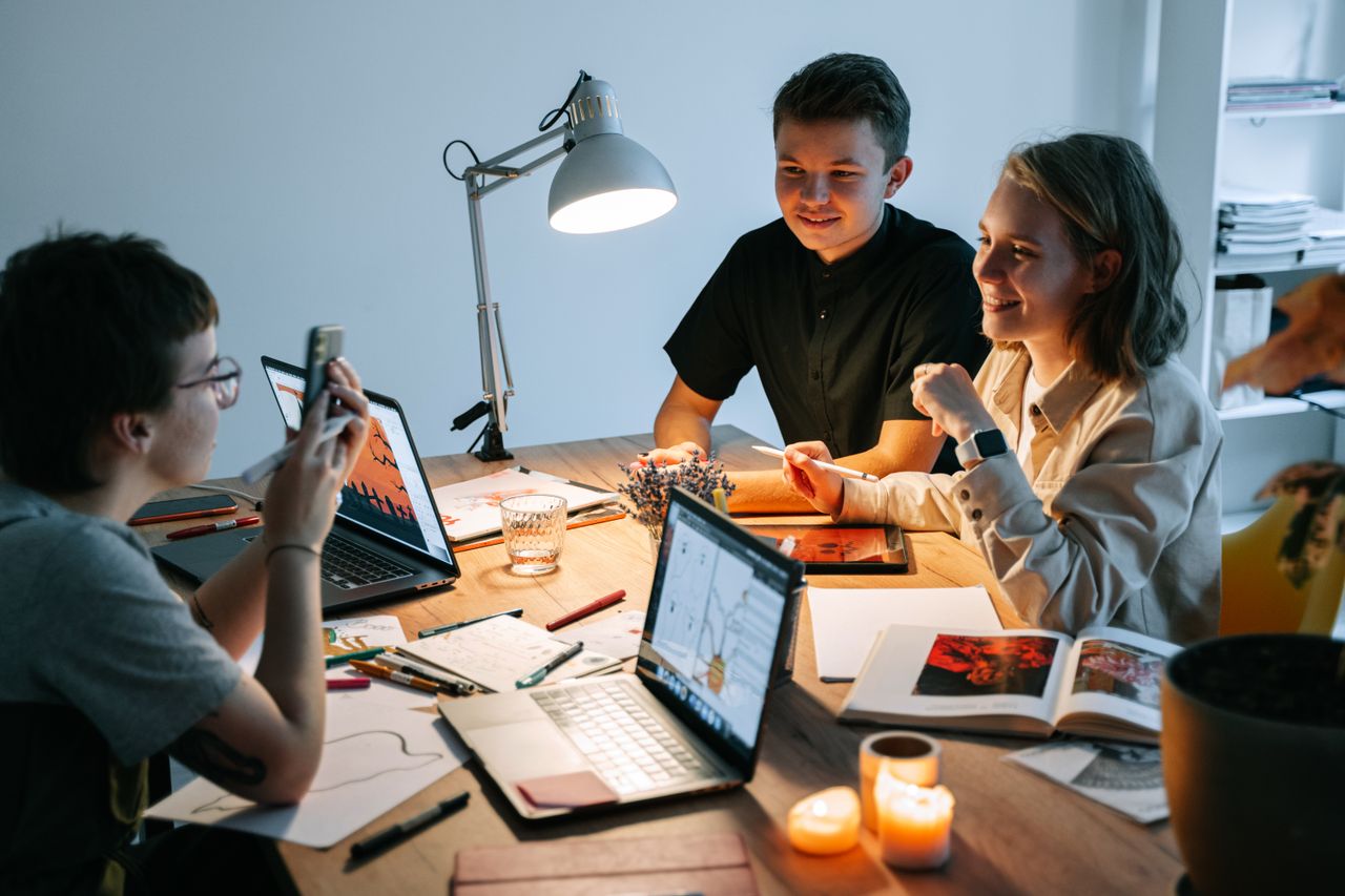 Young professionals brainstorming ideas in a well-lit, creative workspace, fostering teamwork and innovation.